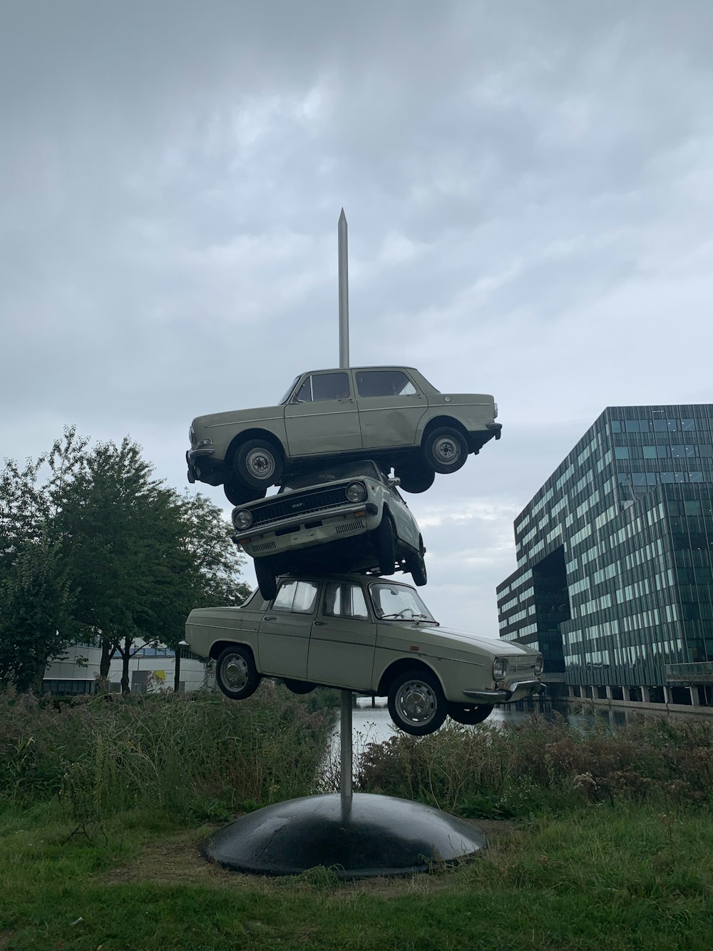 grey and black car statue near high rise building during daytime