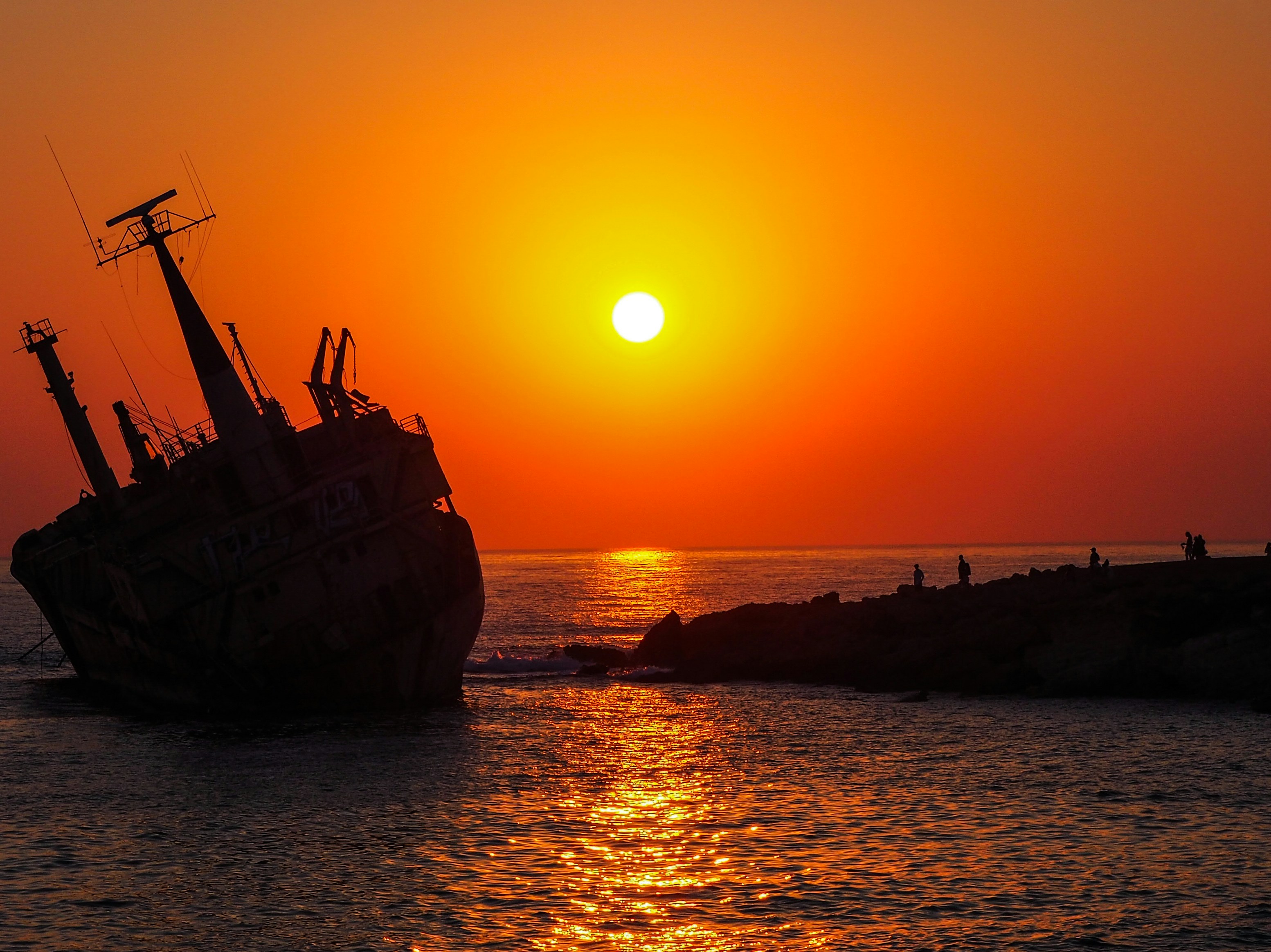 brown ship on sea during sunset