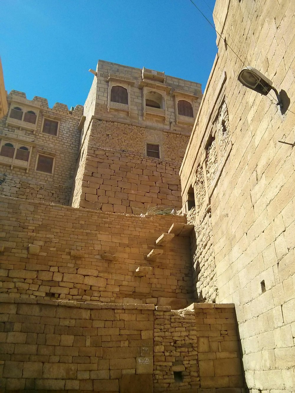 brown concrete building under blue sky during daytime