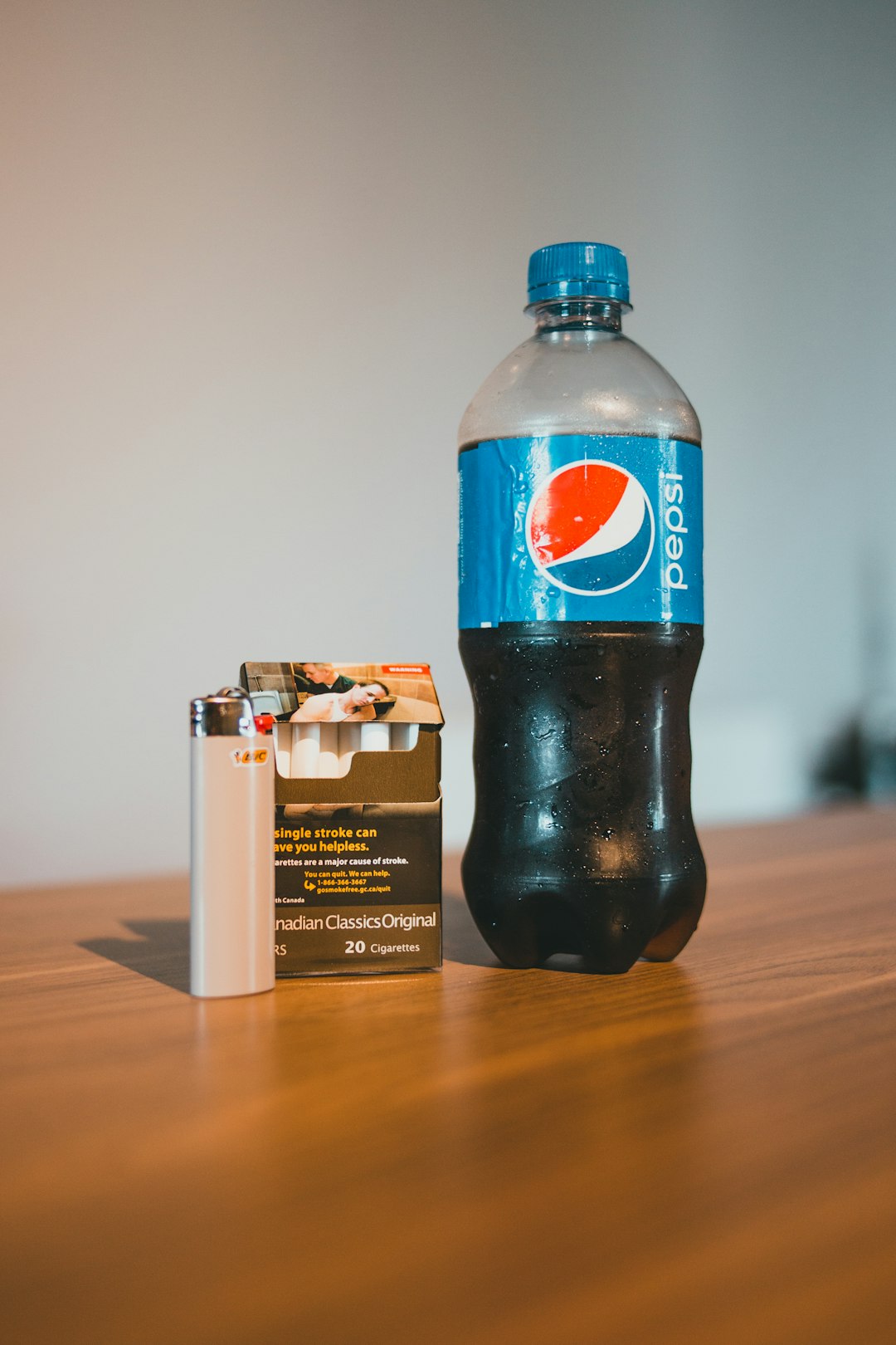 pepsi max plastic bottle on brown wooden table