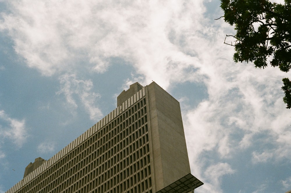 gray concrete building under white clouds during daytime