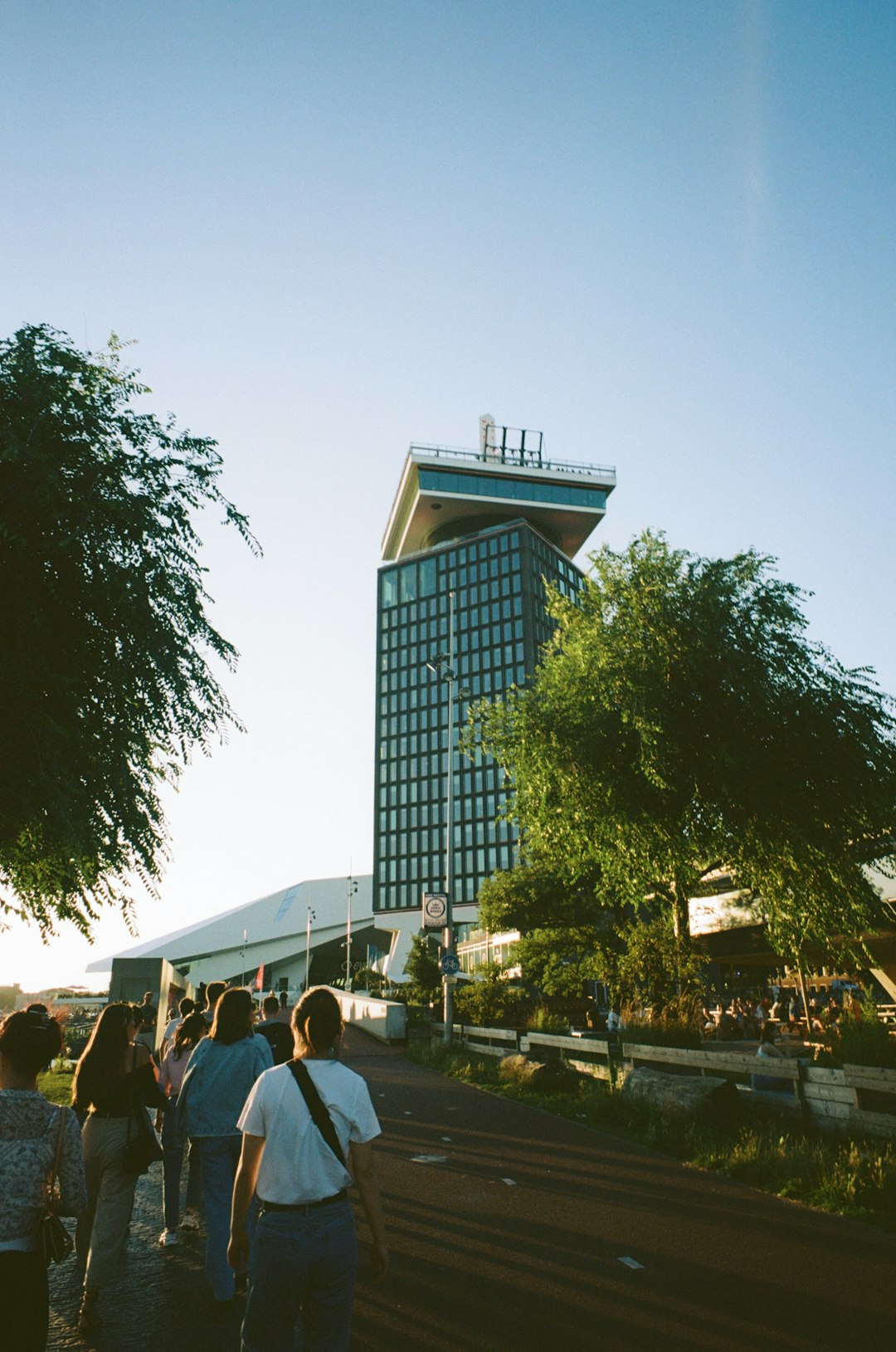 people walking on sidewalk near building during daytime