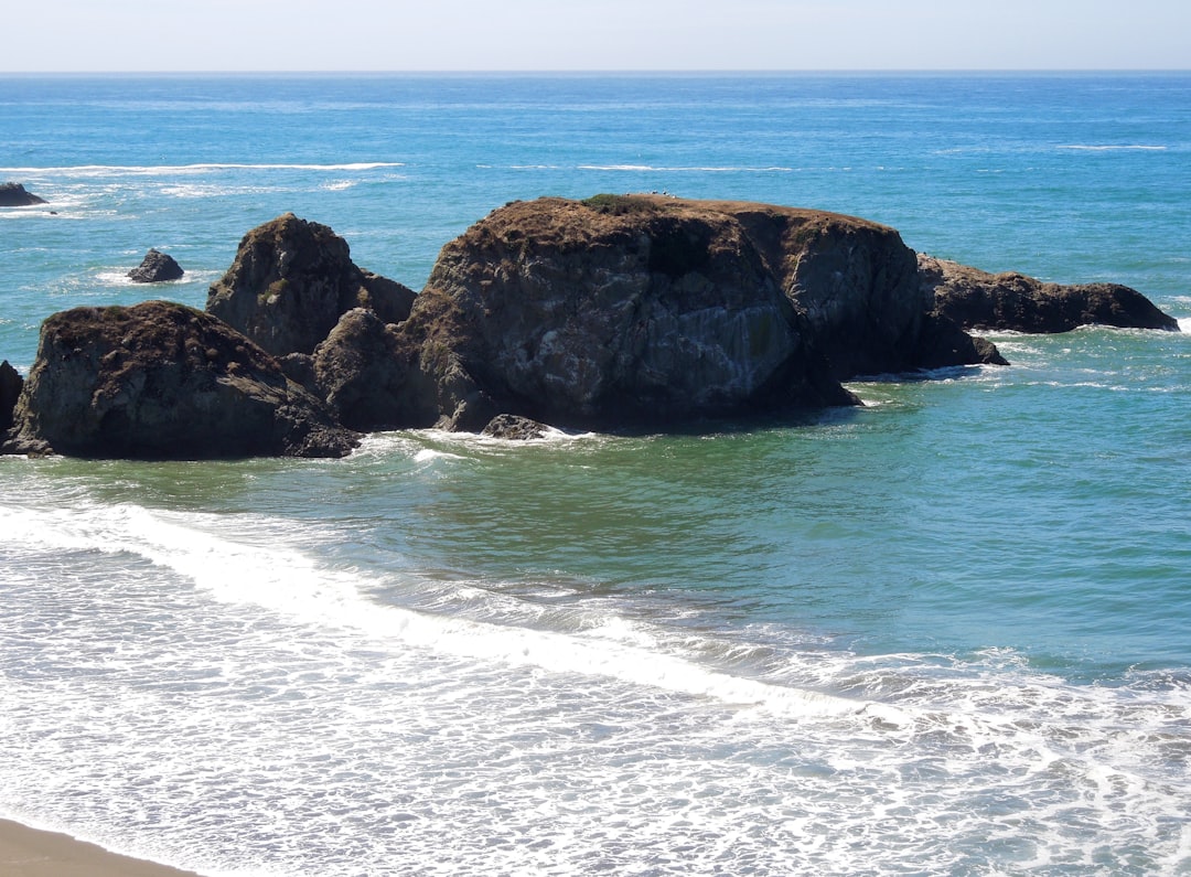 brown rock formation on sea during daytime