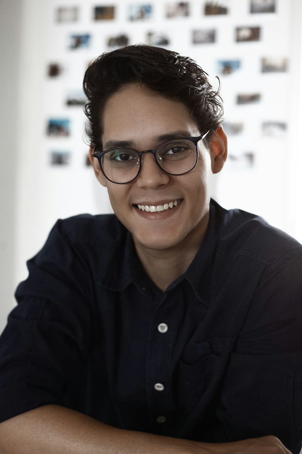 man in black dress shirt wearing black framed eyeglasses