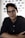 man in black dress shirt wearing black framed eyeglasses