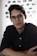 man in black dress shirt wearing black framed eyeglasses