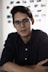man in black dress shirt wearing black framed eyeglasses