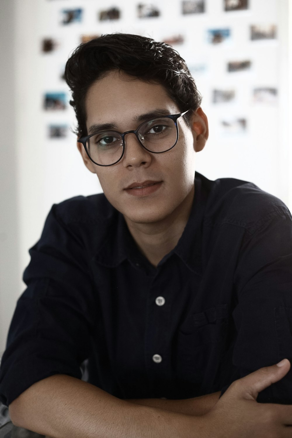 man in black dress shirt wearing black framed eyeglasses