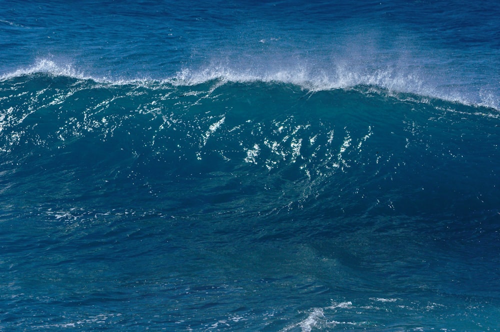 a man riding a wave on top of a surfboard