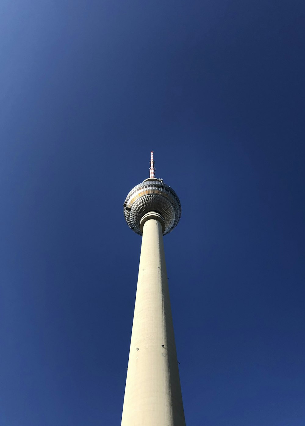a tall white tower with a sky background