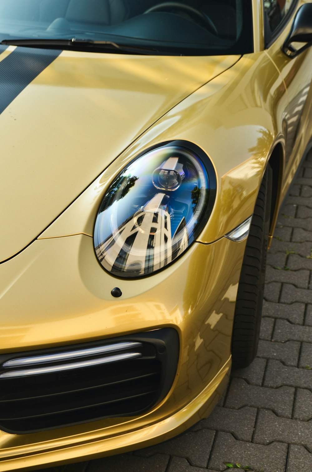 a close up of a yellow sports car