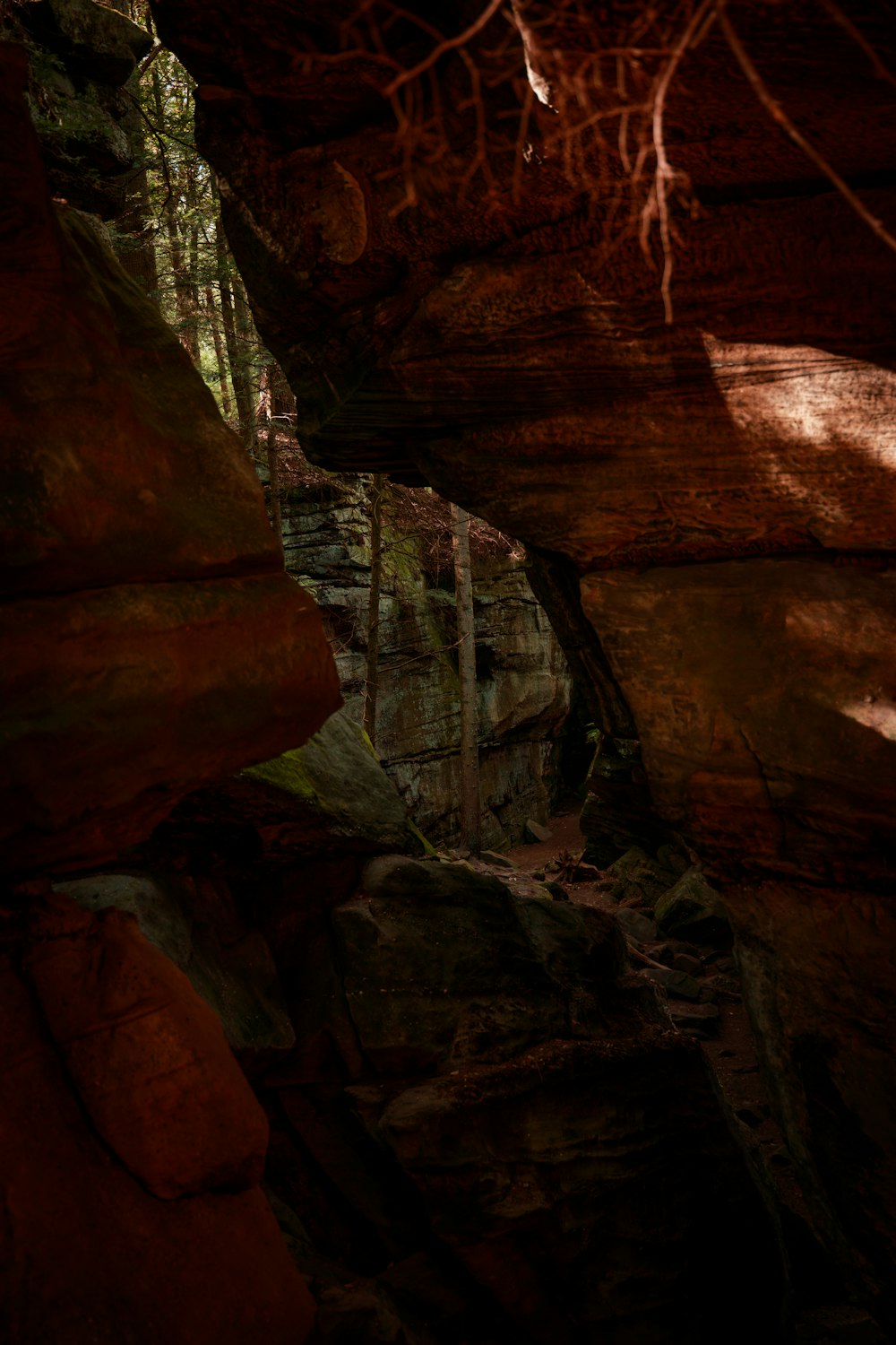 brown rock formation with green metal bridge