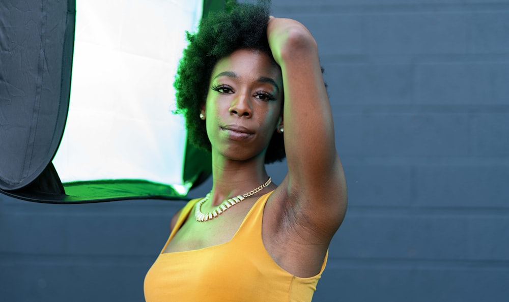 a woman holding a green and white umbrella