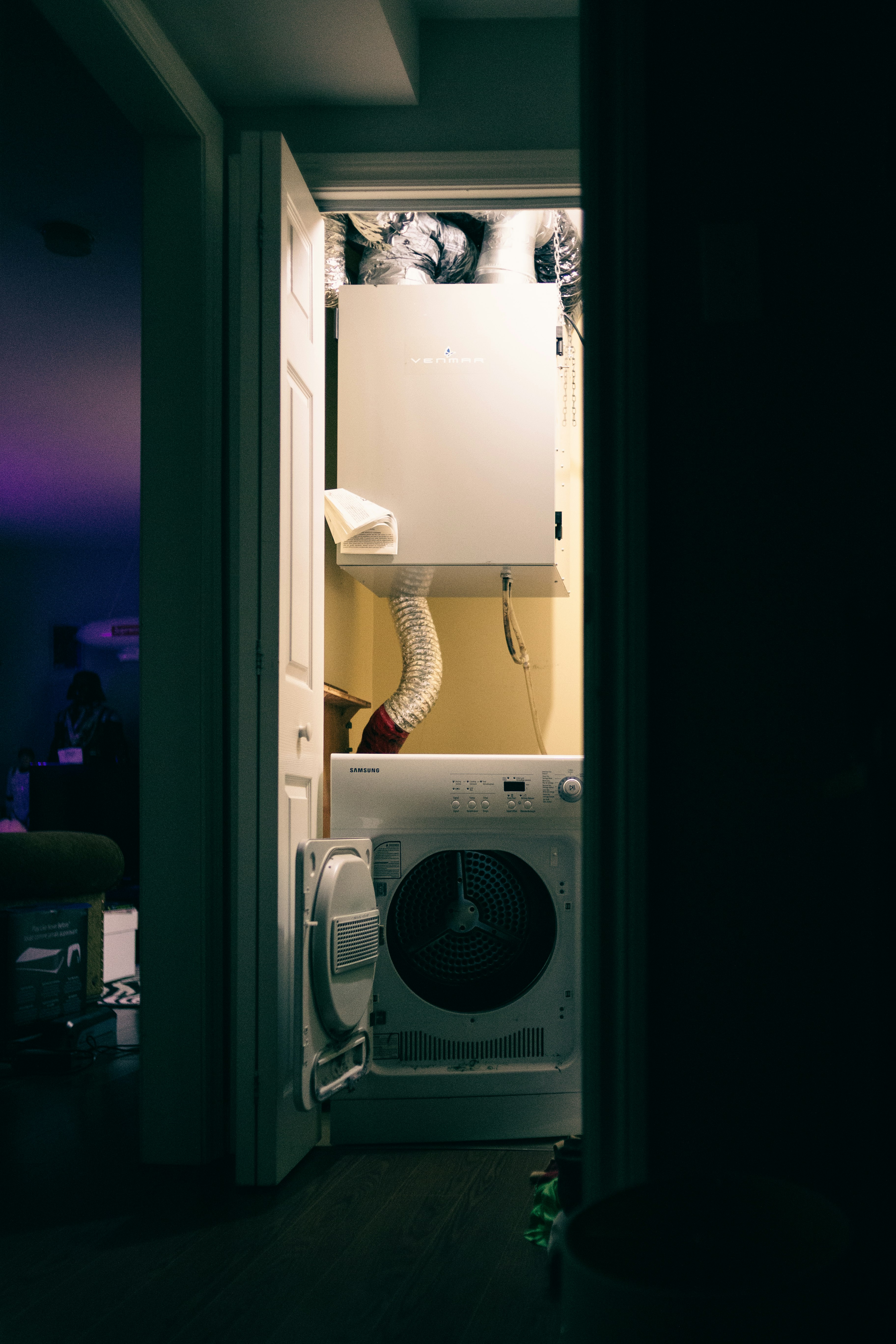 white box fan beside white wooden door