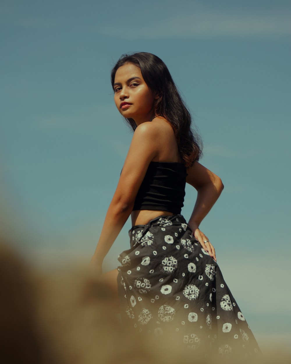 woman in black and white floral dress