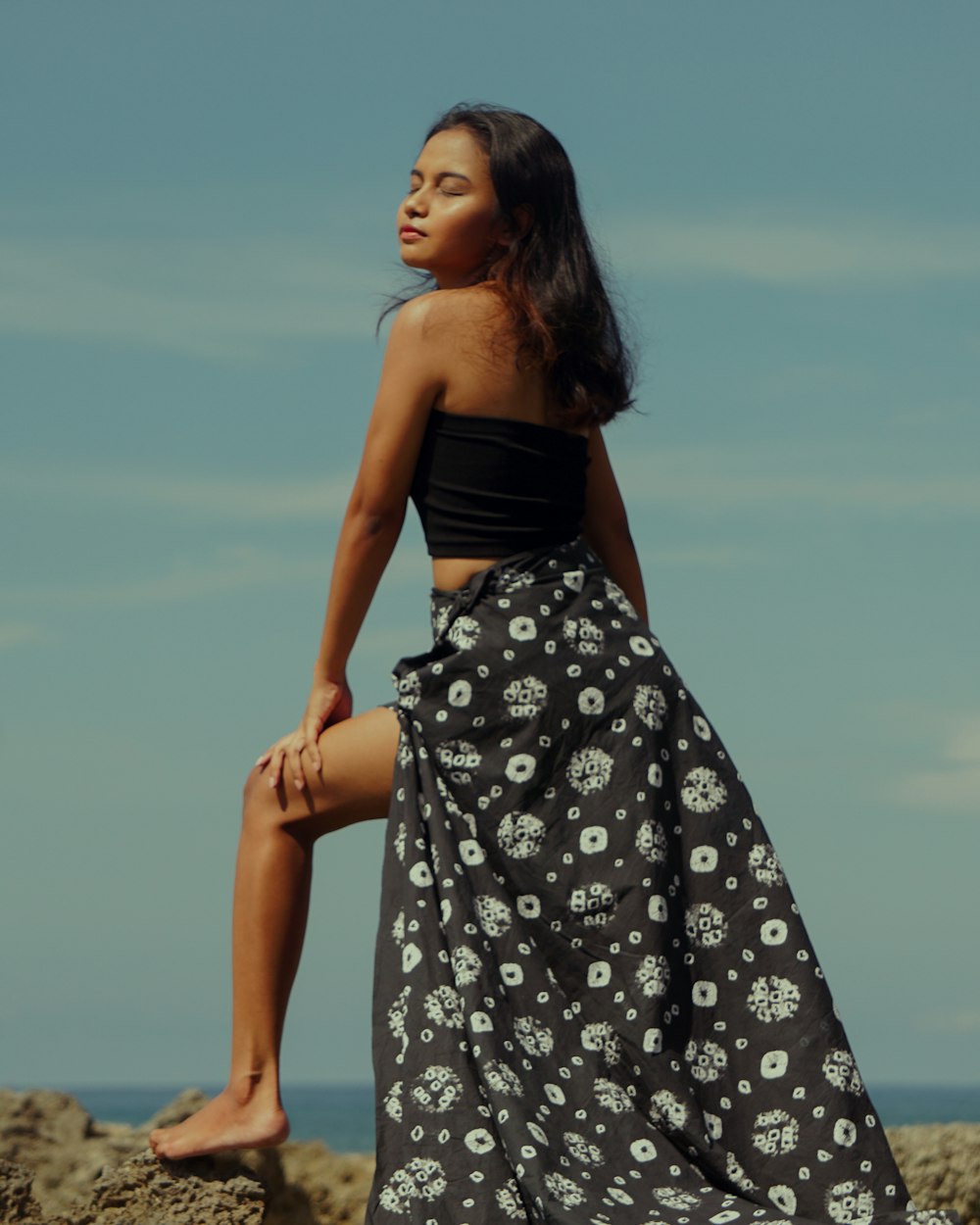 woman in black and white floral tube dress