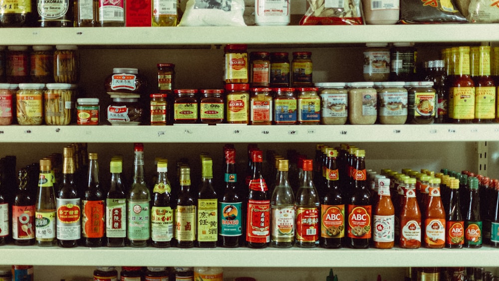 assorted bottles on brown wooden shelf