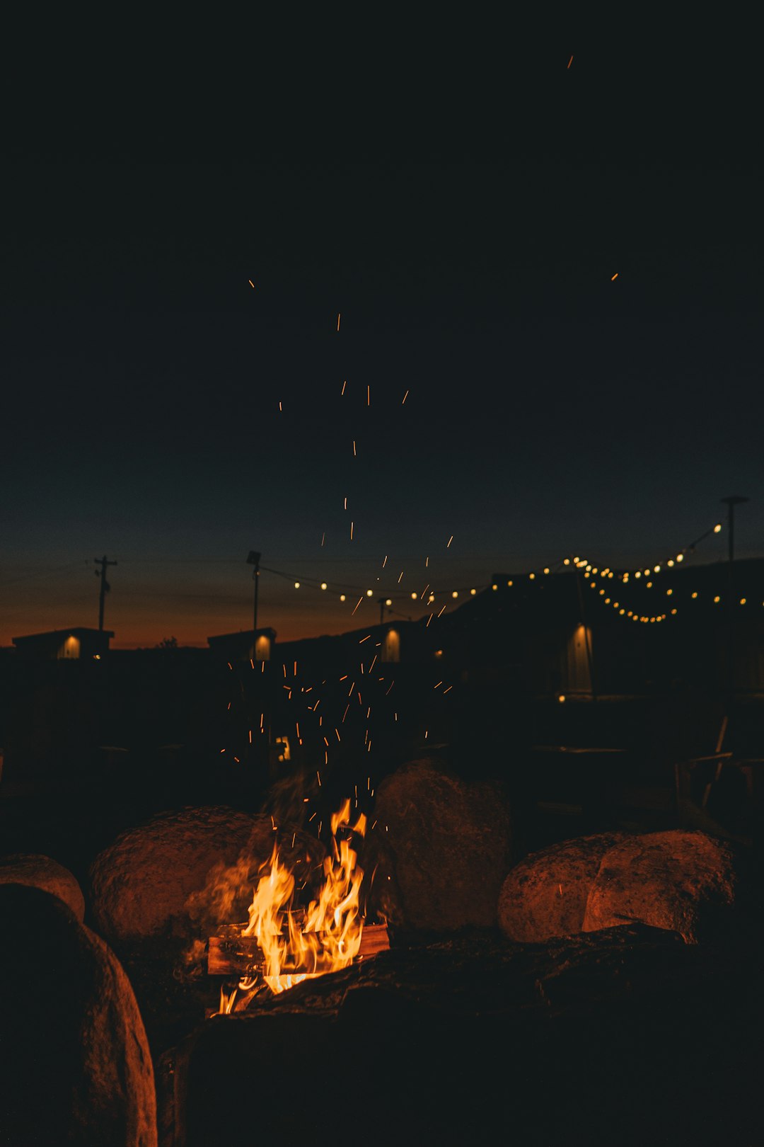 people standing on rock formation during night time