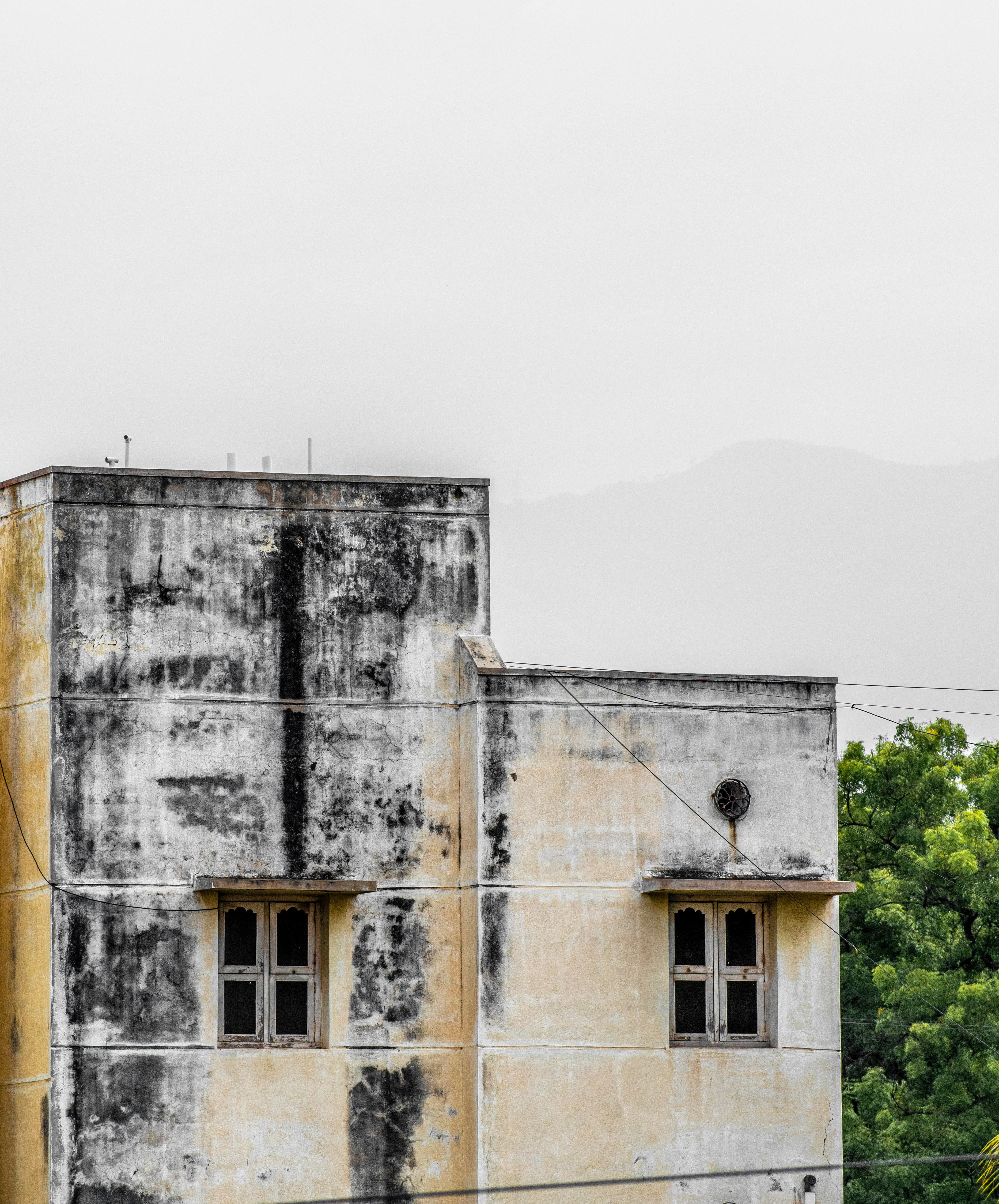 white concrete building near green trees during daytime