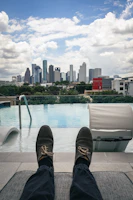 person wearing black and brown shoes sitting on white chair