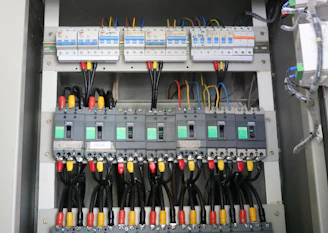 Various types of circuit breakers and electrical panels neatly arranged.