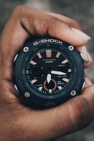 Casio G-Shock watch glowing in low light, highlighting its durable design.