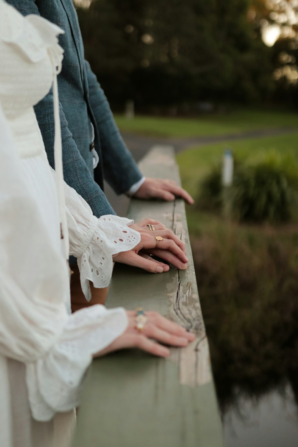 woman in white dress holding man in blue denim jacket