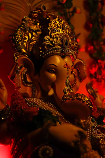 Close-up of a beautifully detailed clay Ganesh idol with soft natural lighting