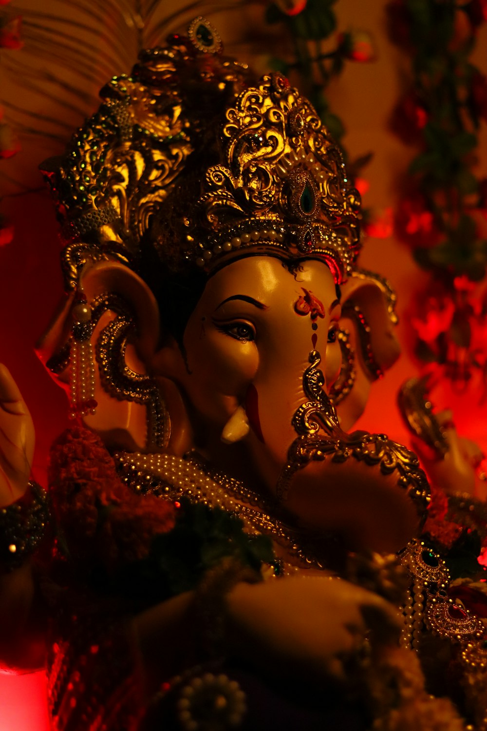 gold hindu deity figurine in red background