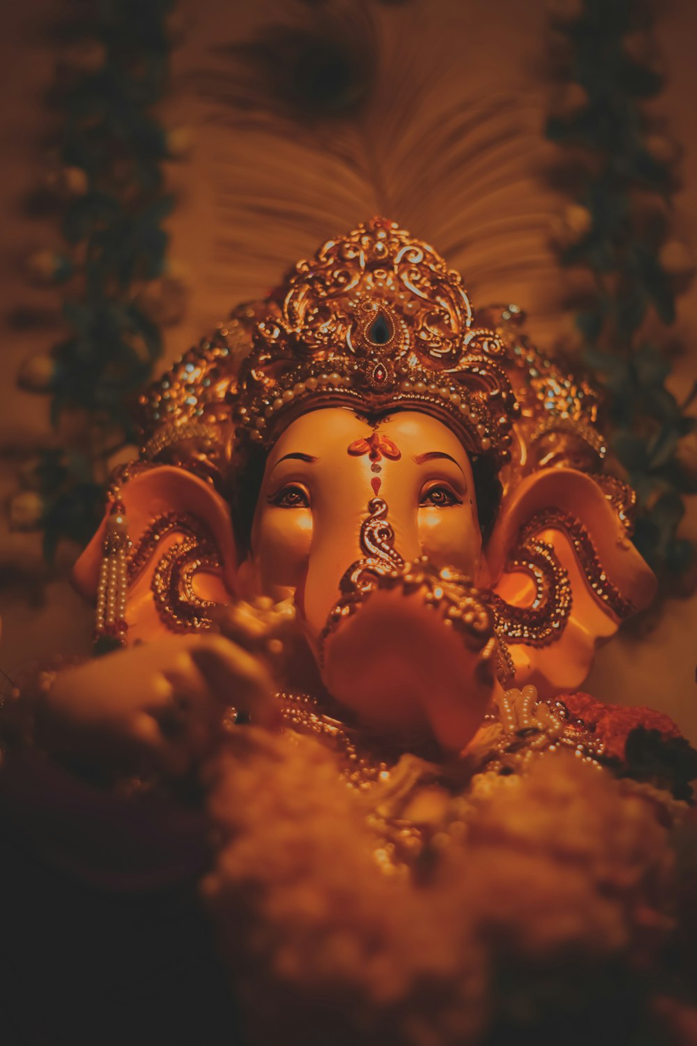 gold hindu deity figurine in close up photography