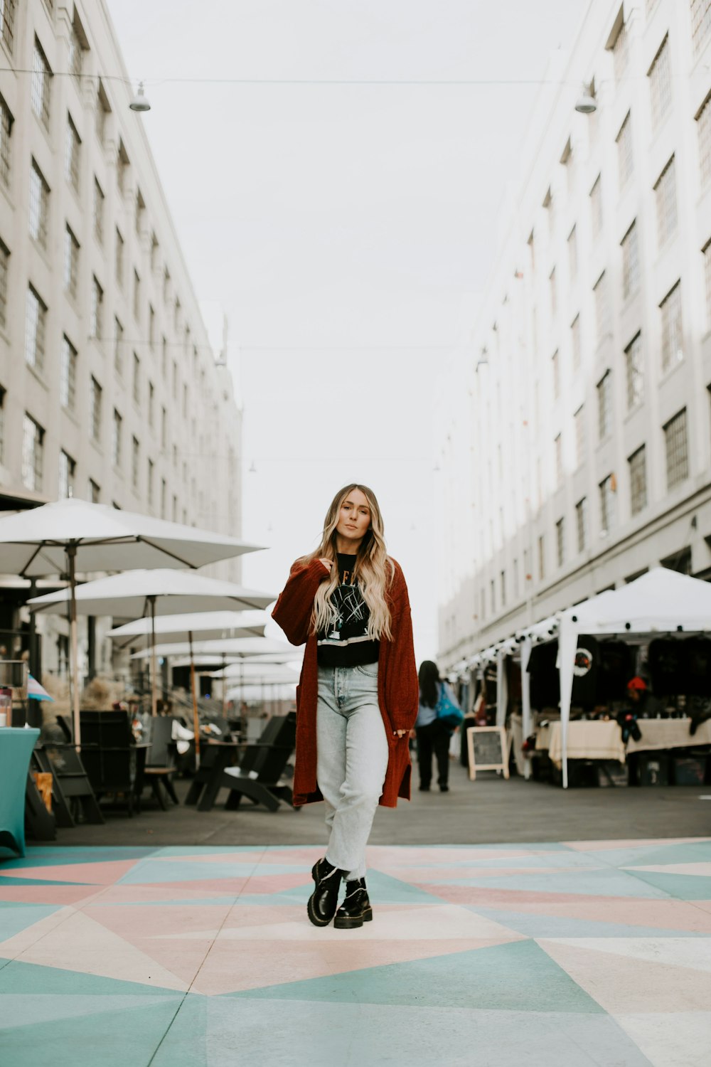 a woman riding a skateboard down a street