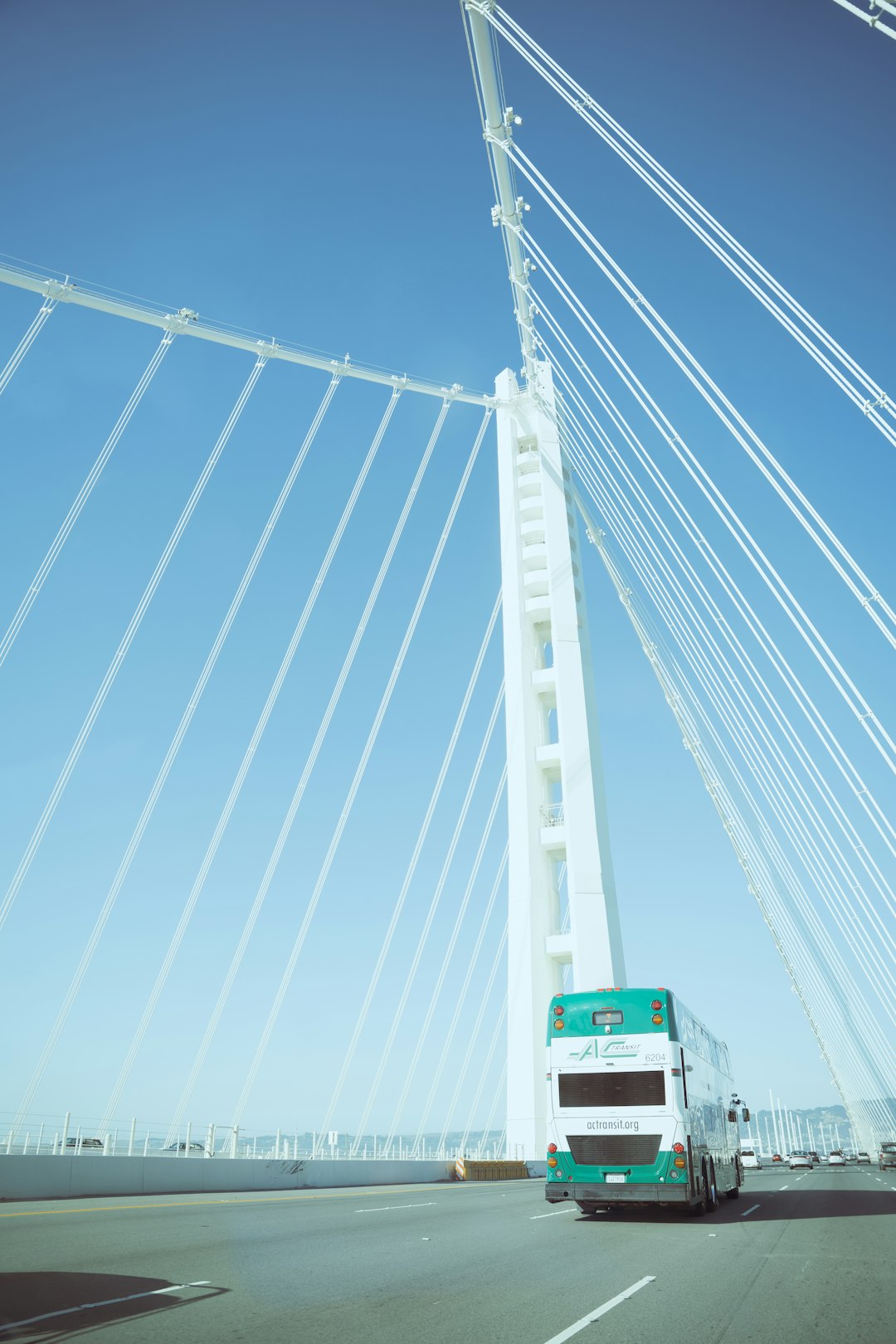 white and red bus on bridge during daytime