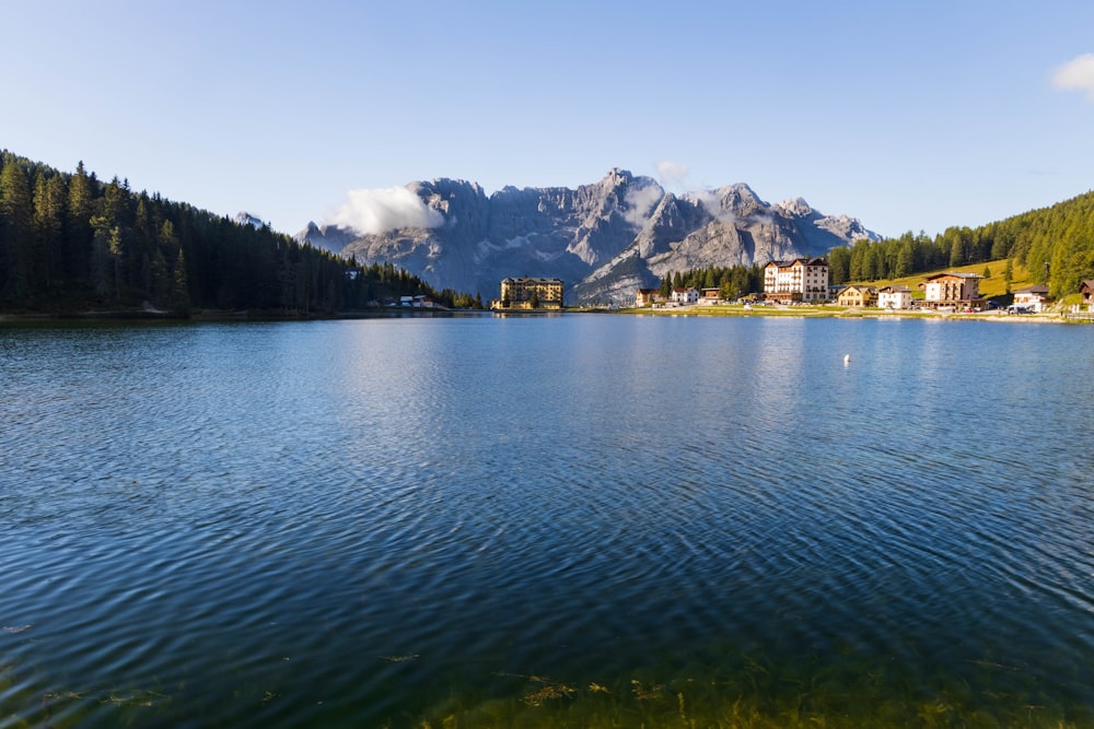 body of water near mountain during daytime