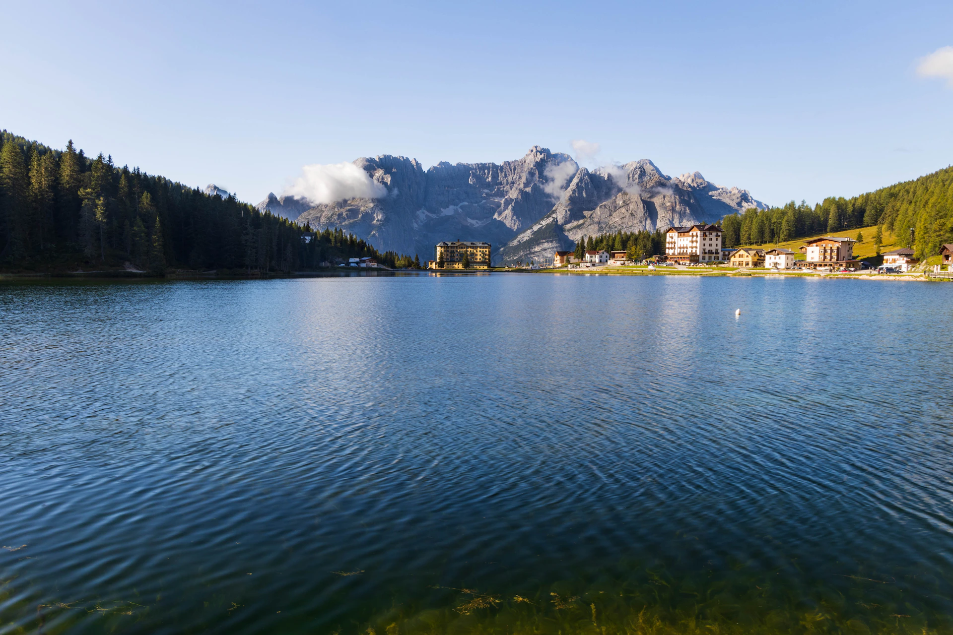body of water near mountain during daytime