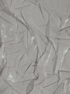 Shiny plastic laminated boxes reflecting light under factory lighting