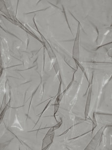 Transparent polycarbonate sheet reflecting light with a soft green tint.