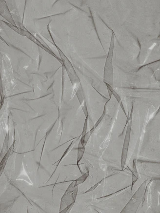 Flexible PCB bending gently over a curved surface, showing its thin, translucent layers.