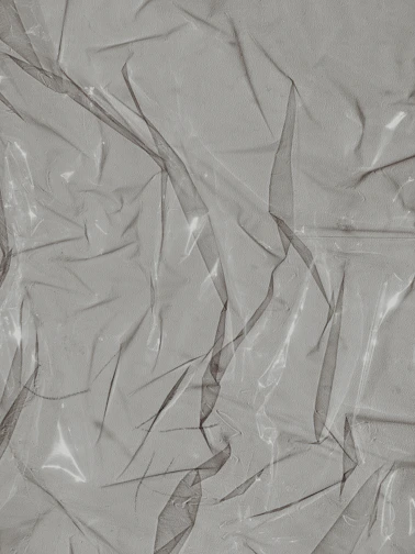 Flexible PCB bending gently over a curved surface, showing its thin, translucent layers.