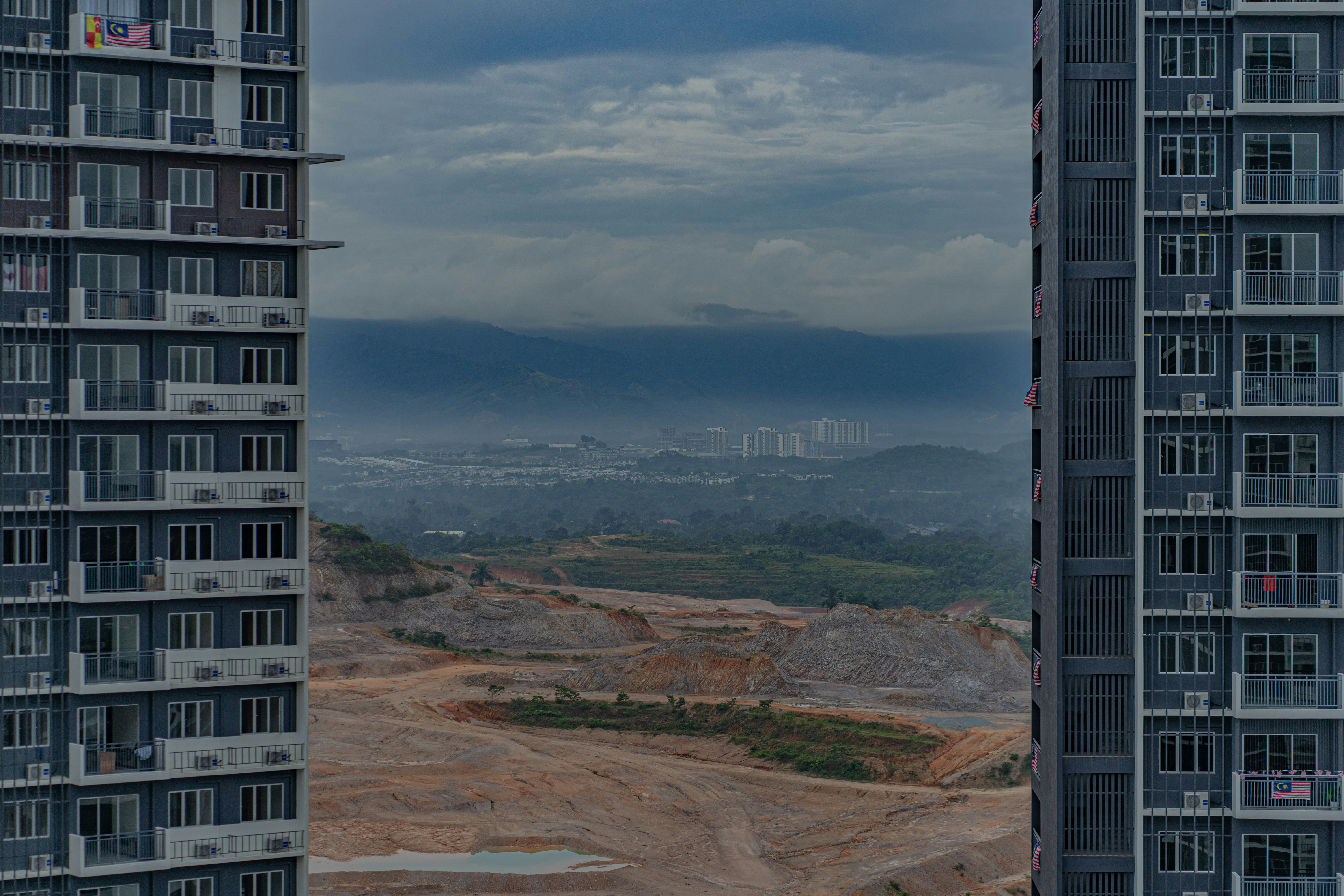 high rise building on brown mountain under blue sky during daytime