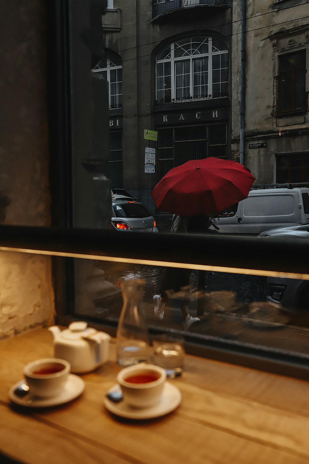 red umbrella on brown wooden table