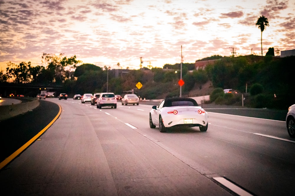 white coupe on road during daytime