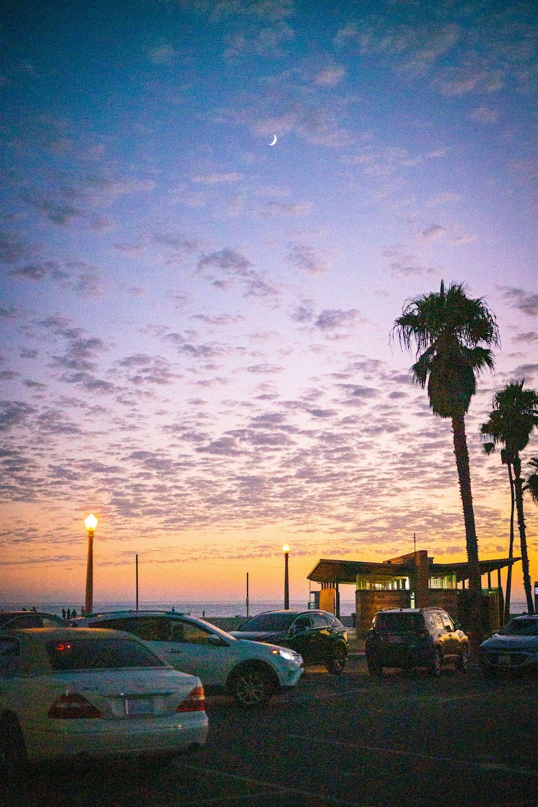 cars parked on parking lot during sunset