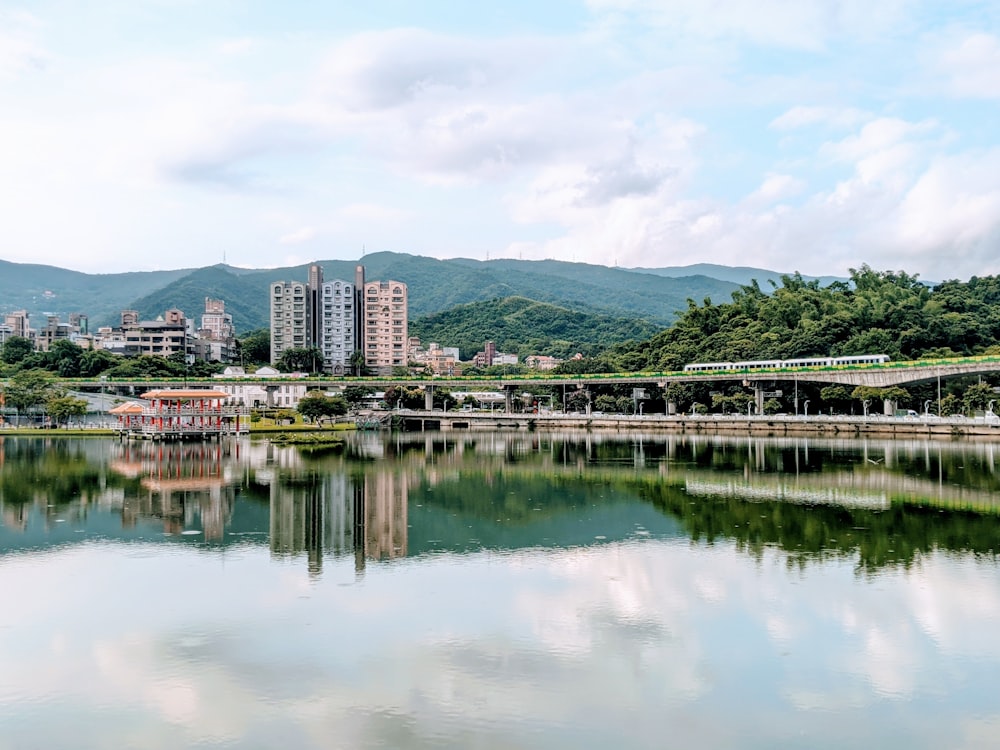 body of water near city buildings during daytime