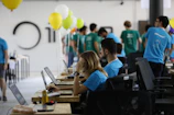 a group of people working on laptops in a room