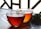 Two glass cups filled with amber-colored tea are placed on a table, accompanied by green leaves and a small red flower. The background shows a pattern of latticework.