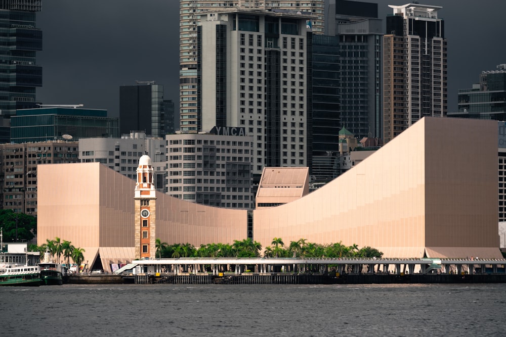 white and brown concrete building near body of water during daytime