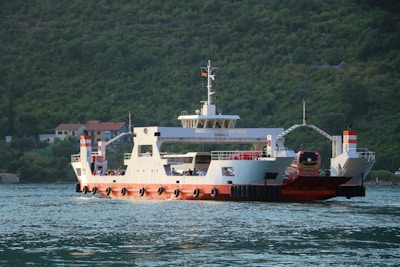 white and red ship on sea during daytime