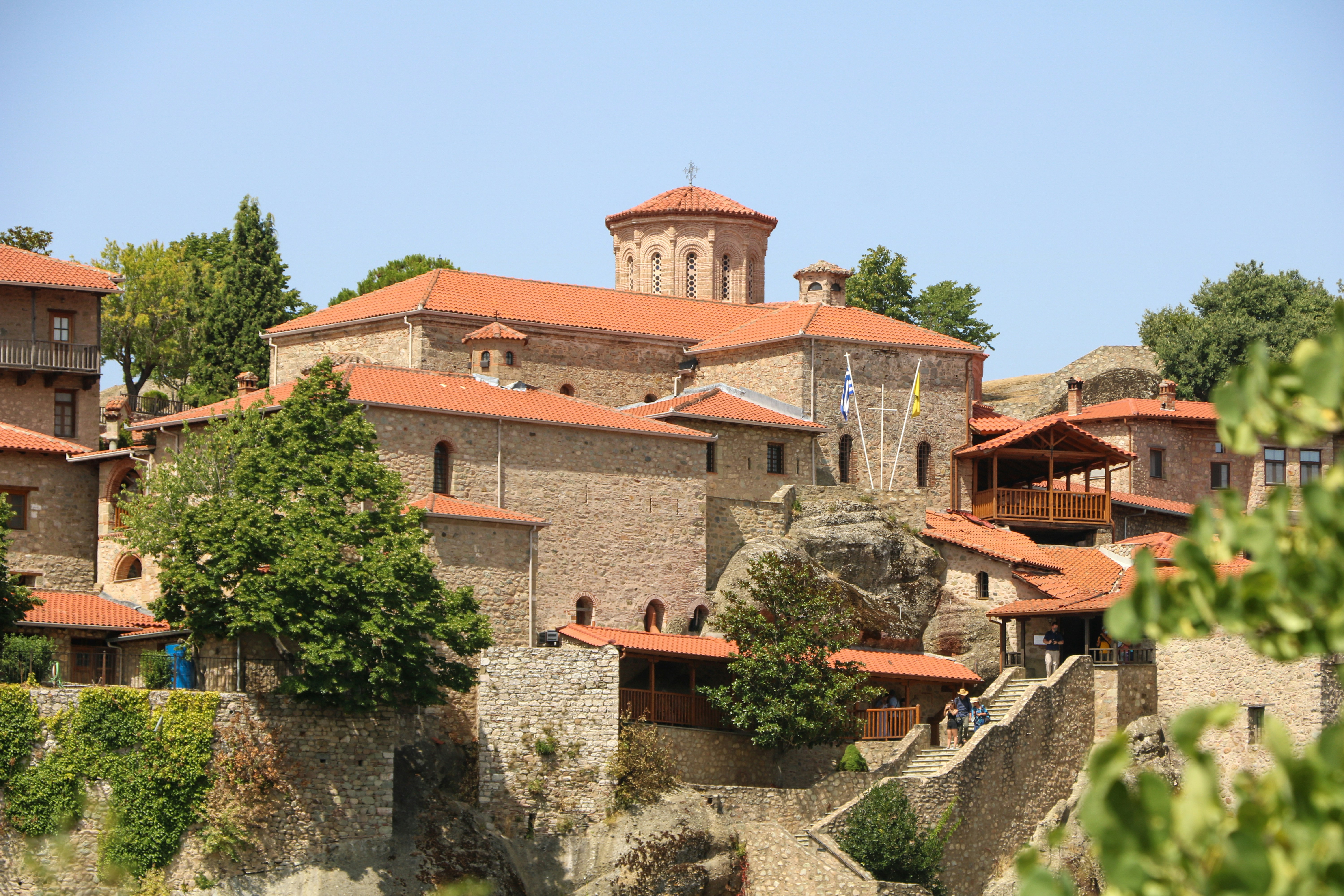 brown concrete building near green trees during daytime