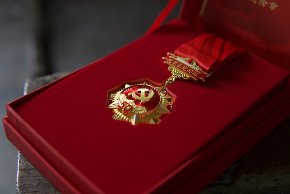 gold and red crown on red padded chair