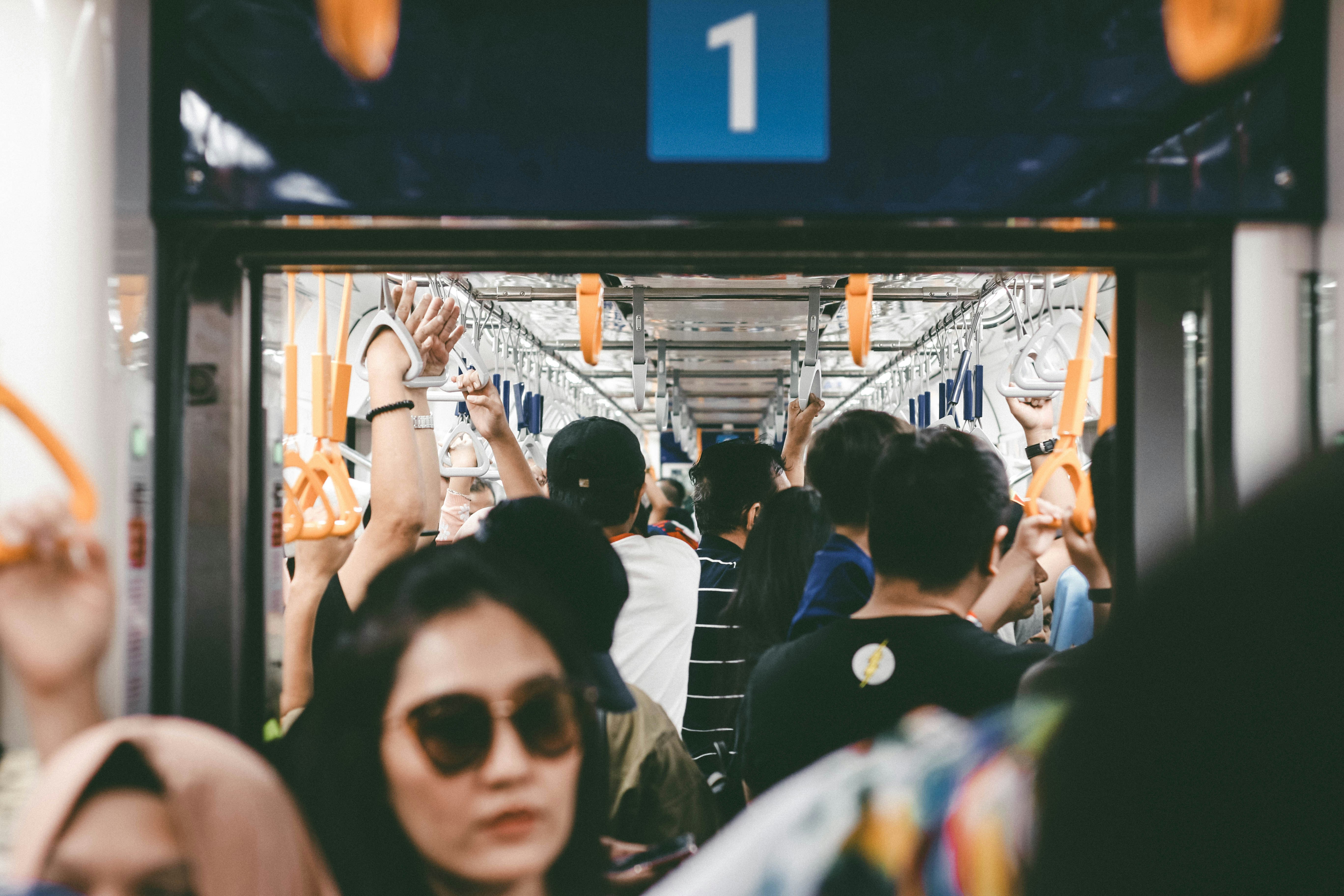 a group of people riding on a subway train